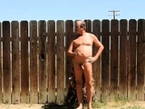 A daddy parading around naked in his backyard.